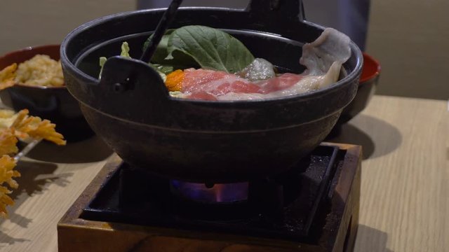 Traditional Japanese hot pot on a wooden table in a restaurant