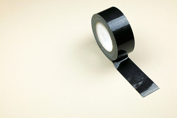 A Roll Of Heavy Duty Waterproof Adhesive Tape On A Cream Backgrond