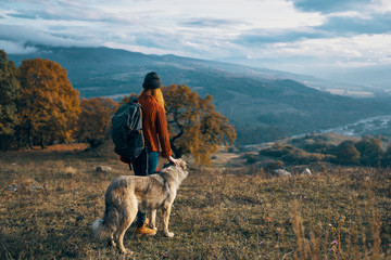 man with dog in mountains
