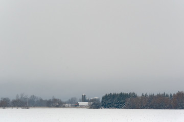 Farm under a snowy sky