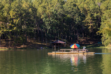 Fototapeta na wymiar tourists traveling on bamboo rafts in lake