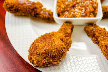Crispy Chicken Drumsticks fry in a white plate with spicy dip sauce