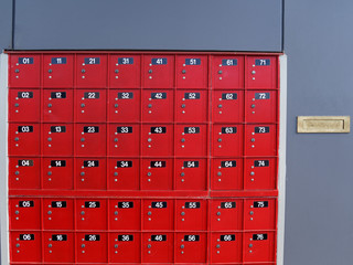 Red post office boxes at a mail centre in New Zealand.