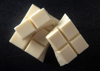 Block of White Chocolate on a Dark Kitchen Cabinet