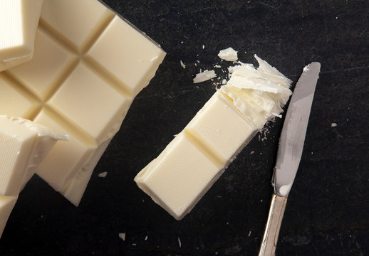 Block of White Chocolate on a Dark Kitchen Cabinet - Powered by Adobe