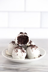 A Pile of White Chocolate Covered Chocolate Sandwich Cookie Truffles