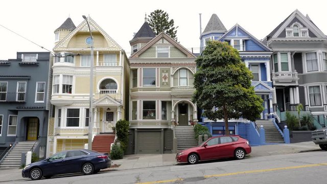 The famous Painted Ladies and parked cars in San Francisco, California