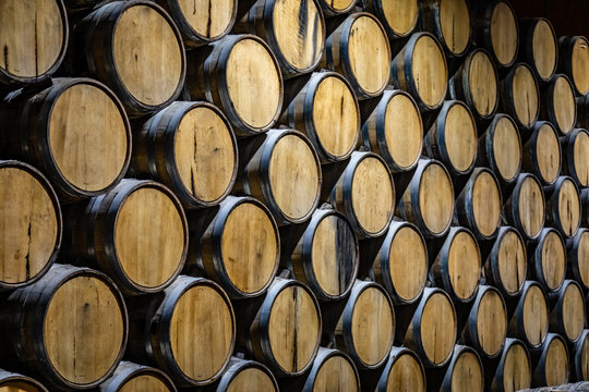 Huge Stack Of Oak Barrels Aging Tequila In A Warehouse In Mexico