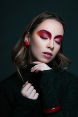 Fototapeta premium fashion beauty portrait of model with modern vogue trendy make up, magazine editorial ready, close up red eye shadows and lipstick, n studio 