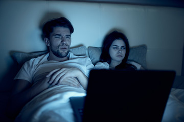 man and woman watching movie on tv