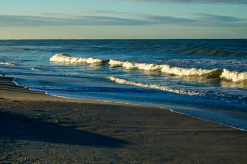 Large cresting waves on bonita beach at the gulf of mexico in bonita springs florida at sunrise.