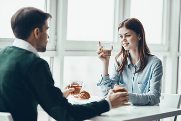 young couple having breakfast in restaurant