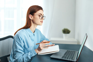 businesswoman working on laptop in office