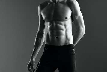 Fototapeta na wymiar man with muscular body isolated on black background
