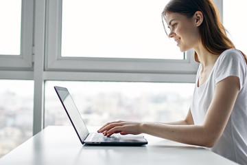 young woman working on laptop at home