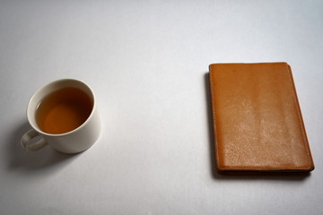 a cup of tea and handmade book jacket on the book