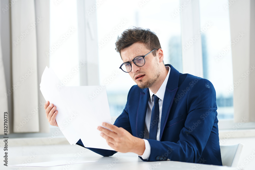 Sticker businessman working on his laptop in office