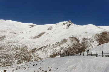 An avalanche fence on a snowy mountain