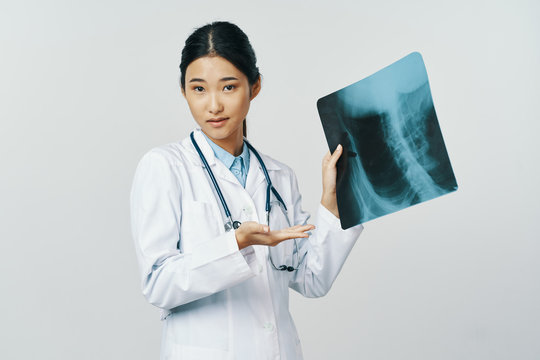 female doctor looking at an xray