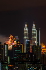 KUALA LUMPUR, MALAYSIA - 1ST JANUARY 2020; Fireworks explode near Malaysia's landmark Petronas Twin Towers during New Year celebrations in Kuala Lumpur.