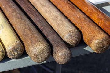 old baseball bats layed out in a row