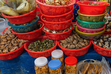 Assortment of snails contained in basket at Asian seafood market