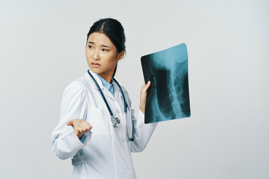 female doctor looking at an xray