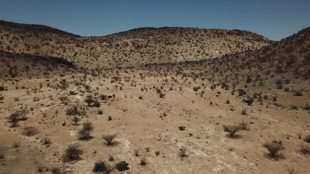 4K aerial drone video of gravel plains and Erongo Mountains near town Usakos, B1 highway to west coast of Namibia and dry waterless hot bushy savanna in Karibib District, central Namibia