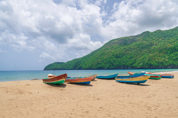 Fototapeta na wymiar Old fisherman boats on the beach at the day,Samana beach,Dominican Republic.