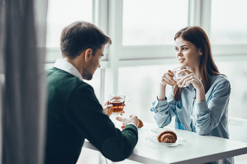young couple having breakfast in the kitchen