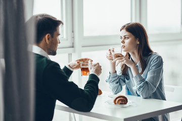 young couple having breakfast in cafe