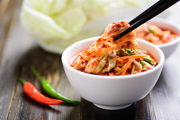 Kimchi cabbage in a bowl with chopsticks, Korean food