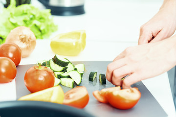 woman cutting vegetables in kitchen