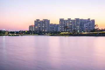 Fototapeta na wymiar Lake view residential building in Phoenix Lake Park, Nansha, Guangzhou, China