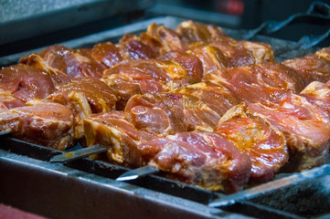 Harvesting meat for barbecue. Raw meat for muggle. Meat on skewers.