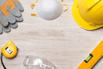 Yellow hardhat, gloves and hammer isolated