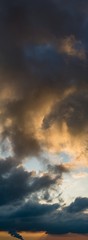 Fantastic clouds at sunrise, vertical panorama