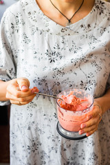 Homemade tomato sauce in woman's hands. Sauce in blender, mixer or food processor's jar.