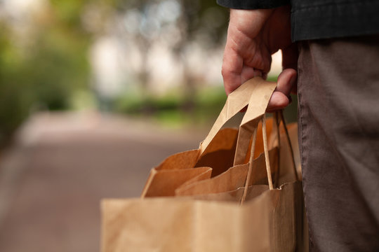 plastic free shopping concept, hand holding paper bags closeup