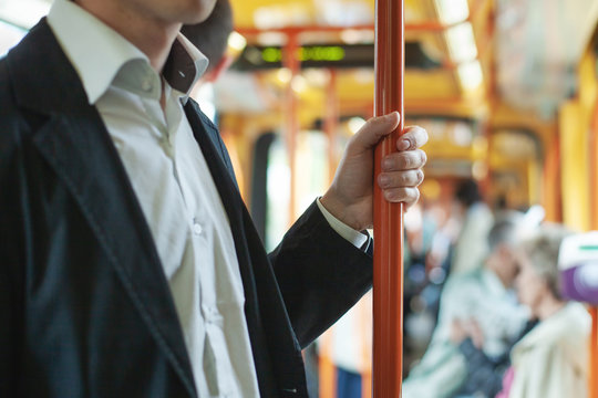 Passenger Commuter In Public Transport, Commuting People In Bus Or Tram, Close Up Of Hand Holding Handrail Bar