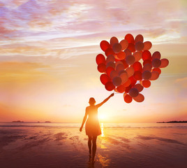 inspiration, dream and creativity, happy life, woman with many balloons at sunset