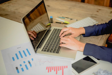 Businesswomen using a laptop to analysis marketing.