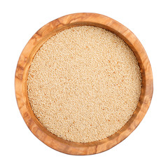 Amaranth seeds  in wooden bowl isolated on white background. Top view, close-up.