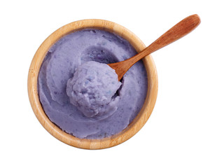 Mashed  purple potatoes in wooden bowl isolated on white background. Top view.