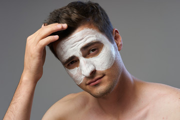 portrait of young man with facial mask on her face