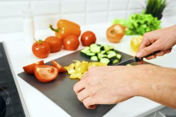 woman cutting vegetables in kitchen