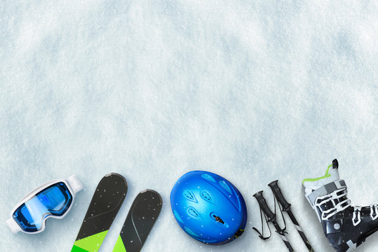 Ski equipment placed on snow. Free space above for text, logo promotion. Winter ski vacation concept. To view, flat lay