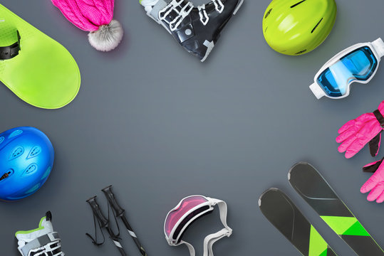 Ski and snowboard equipment placed on the table with copy space in the middle for text, logo or product promotion. Top view, flat lay.