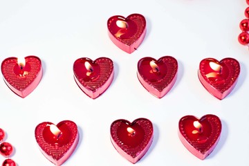 a heart shaped candle on a white background is a symbol of love