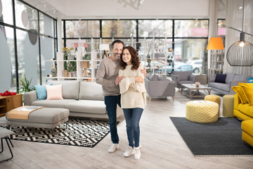 Two people standing in a modern furniture shop